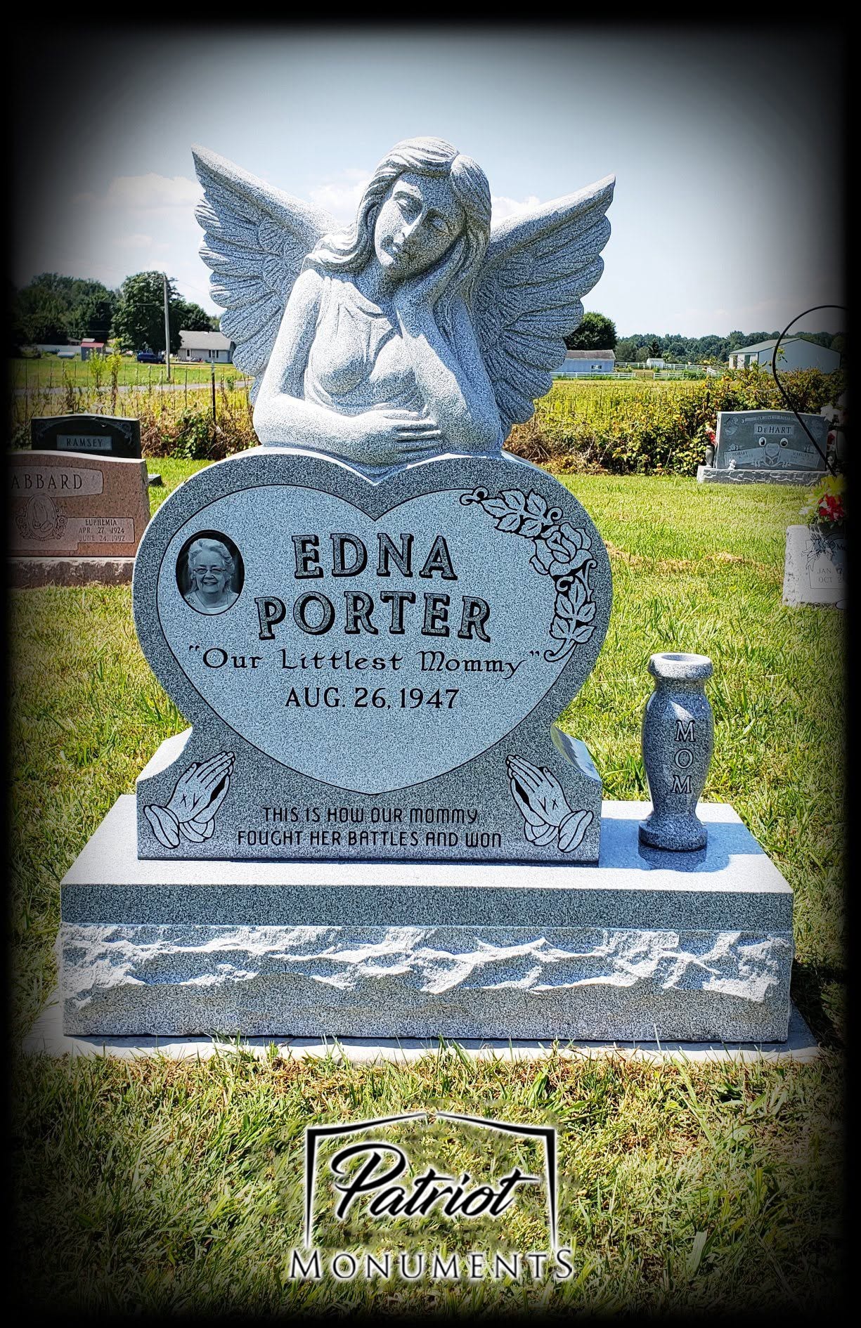 Edna Porter gray granite heart-shaped monument with angel statue and portrait photo